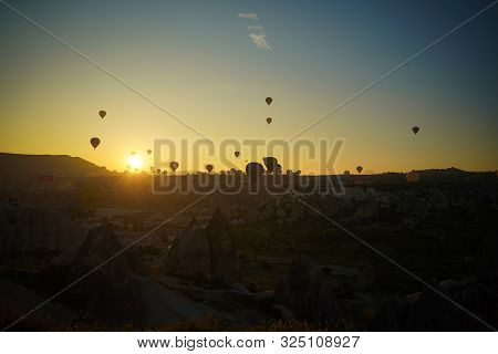 Sunrise Panoramic View To Goreme City And Flying Balloons Over Pigeon Valley Cappadocia, Turkey