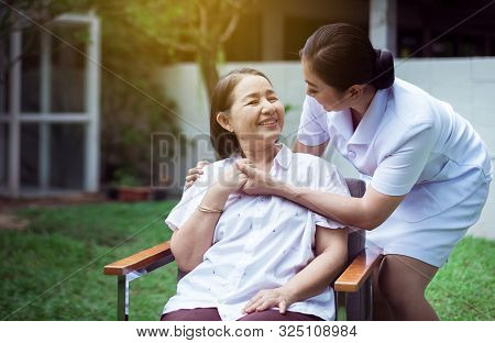 Nurse Holding Hands To Elderly Asian Woman With Alzheimer Disease,positive Thinking,happy And Smilin