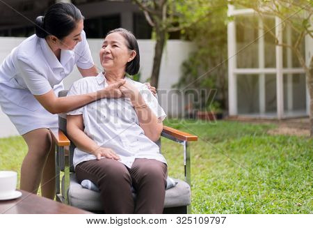 Nurse Holding Hands To Elderly Asian Woman With Alzheimer Disease,positive Thinking,happy And Smilin