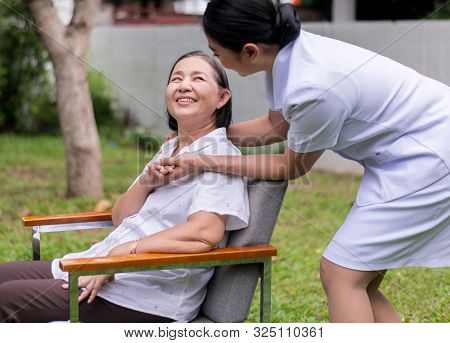 Nurse Holding Hands To Elderly Asian Woman With Alzheimer Disease,positive Thinking,happy And Smilin