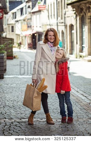 Happy Mother And Daughter At The City