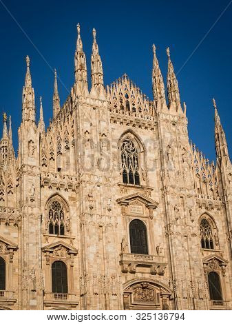 Ornate Facade Of Milan Catehdral In Italy At Sunset
