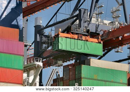 Cargo containers loaded on a huge ship in an intermodal freight terminal