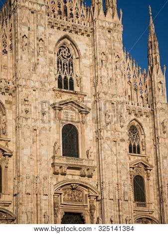 Ornate Facade Of Milan Catehdral In Italy At Sunset