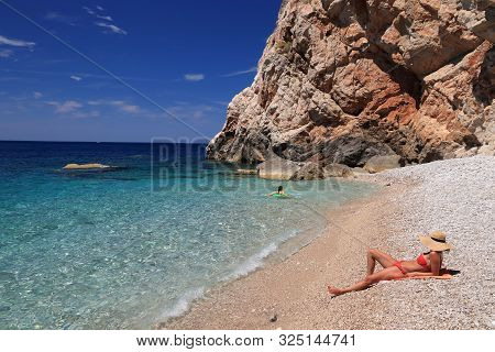 Konavle, Croatia - June 28, 2019: People Spend Vacation At Pasjaca Beach Below Cliffs In Konavle Reg