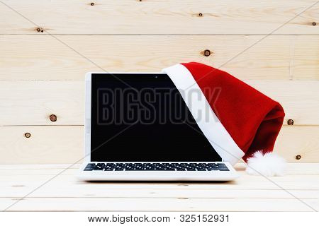 Laptop With Blank Screen And Santa Slaus Hat