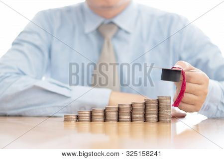 A Businessman Saveing Coin For Eudcation Concept