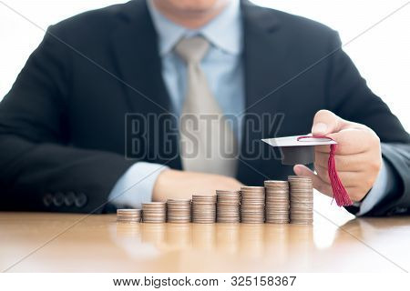 A Businessman Saveing Coin For Eudcation Concept