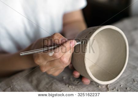 Female Hands Hold A Bowl For Casting Clay Products.