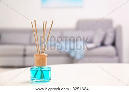 Reed Air Freshener With Essential Oil On Table In Room. Space For Text