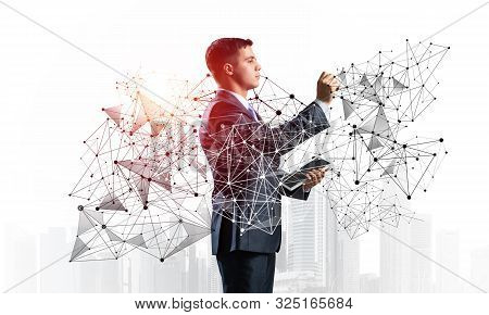 Business Person Pointing On Abstract Network Structure. Standing Personal Assistant In Business Suit