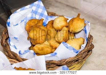 Pettole, Italian Donuts Fried In Oil On A Paper Napkin In A Basket. Made In Puglia. Served As An App
