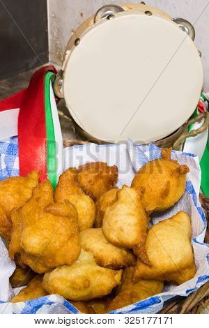 Pettole Italian Donuts Fried In Oil On A Paper Napkin In A Basket. Made In Puglia, Near A Traditiona
