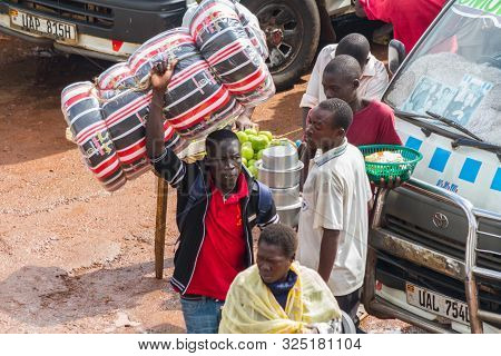 Kampala, Uganda - October 03, 2012.  A Man Carries A Mattress Above His Head At The Taxi Park In Kam