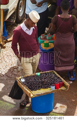 Kampala, Uganda - October 03, 2012.  A Young Man Stands By His Tray Of Beans For Sale At The Taxi Pa