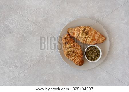 Fresh Croissants With Zaatar On Light Stone Background. Top View