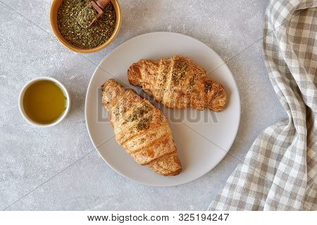 Fresh Croissants With Zaatar And Olive Oil On Light Stone Background. Top View