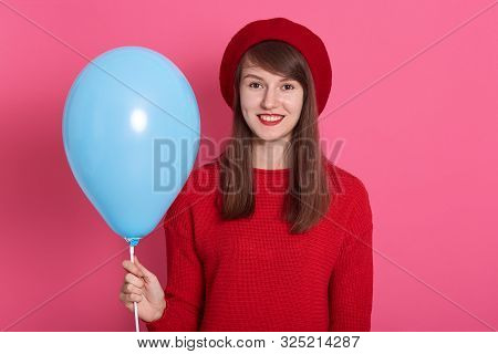 Beautiful Hipster Young Woman With Bright Lipstick Makeup, Wearing Redsweater And Beret, Holding Blu