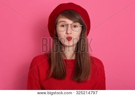 Beautiful Lady Showing Kiss Gesture, Isolated Over Pinkstudio Background, Dresses Red Beret, Sweater