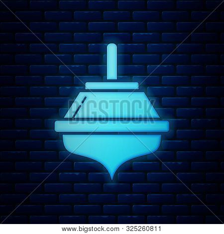 Glowing Neon Hanukkah Dreidel Icon Isolated On Brick Wall Background. Vector Illustration