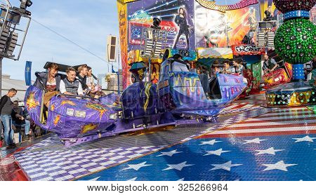 Munich, Germany, 2019 September 28: Visitors Enjoy On An Amusement Park Ride. Breakdancer Fun Ride, 