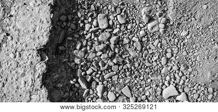 Broken Road With Potholes, Asphalt Surface Destroyed. Bad Road Condition That Needs Repair. Banner S