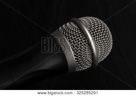 Close-up Black Microphone Head Isolated On Black Background.