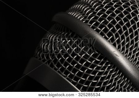 Close-up Black Microphone Head Isolated On Black Background.
