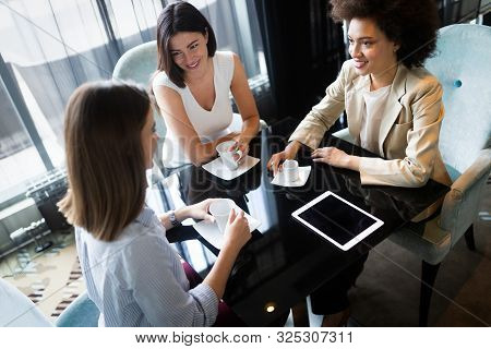 Happy Friends Having A Good Conversation Sitting In A Restaurant