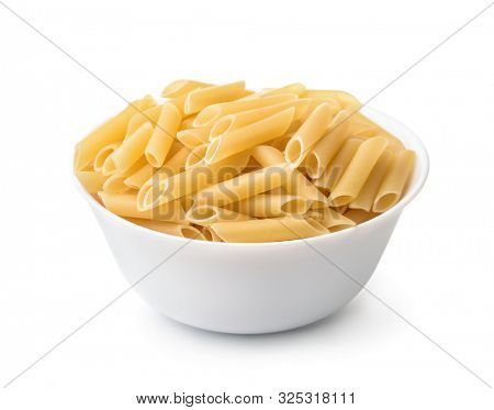 Bowl of uncooked penne lisce pasta isolated on white