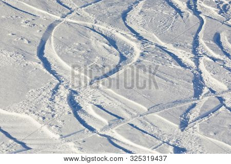 Ski and snowboard curves in the fresh snow slope