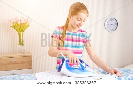 Pretty girl irons clothes idoors