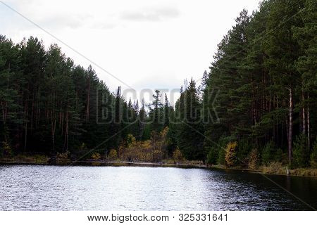 Beautiful Panoramic View Of Big Lake In The Middle Of The Forest.