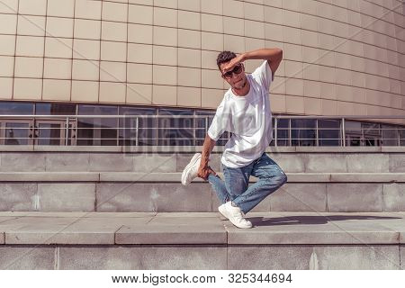 Male Athlete, Guy Dancer Summer City. Stand On One Leg With Glasses. Fashionable Modern Break Dance 