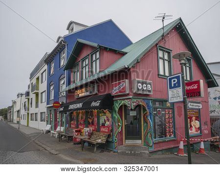 Iceland, Reykjavik, July 30, 2019: Street In Reykjavik Center With Old Historic Pink Sheet Metal Hou