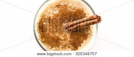 Homemade Eggnog With Cinnamon In Glass Isolated On White Background. Typical Christmas Dessert. Pano