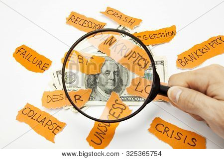 Male Hand Holding Magnifier Above 100 Dollars Stack Bombarded With Problems. Financial Research, Dol