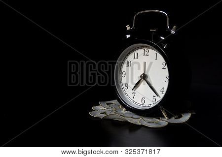 Classic Mechanical Alarm Clock On Dark Background. Low Key