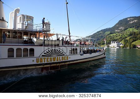 Vitznau, Switzerland 29.09.2019: A Steamboat With Tourist Is Leaving The Port