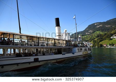 Vitznau, Switzerland 29.09.2019: A Steamboat With Tourist Is Leaving The Port