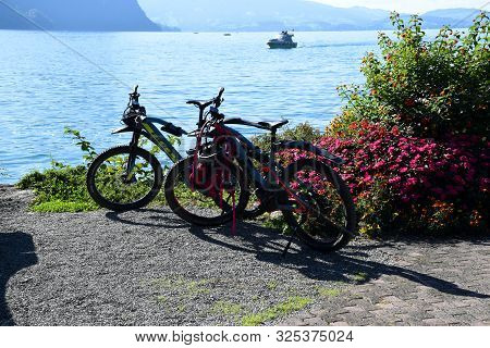 Vitznau, Switzerland 29.09.2019: Mountain Bikes On The Shores Of Lake Lucerne Surrounded By Beautifu