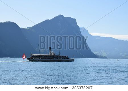 Vitznau, Switzerland 29.09.2019: A Steamboat With Swiss Flag On The Back Is Crossing Lake Lucerne