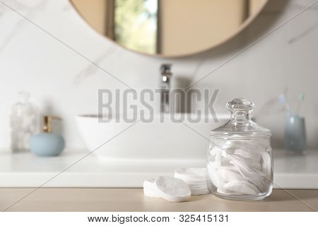 Cotton Pads On Wooden Table In Bathroom
