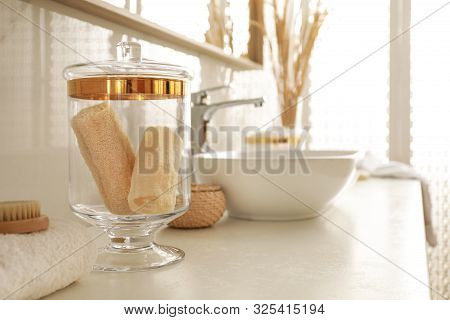 Jar With Loofah Sponges In Modern Bathroom Interior