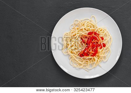 ?lassic Italian Spaghetti Pasta With Tomato Sauce And Basil On Plate On Dark Table. View From Above,