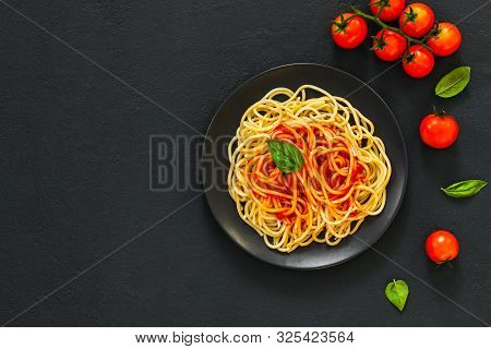 ?lassic Italian Spaghetti Pasta With Tomato Sauce And Basil On Plate On Dark Table. View From Above,