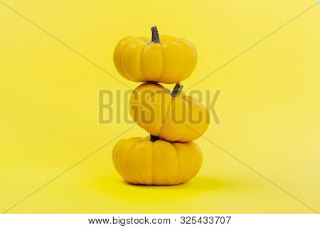 Halloweeen Theme With A Pumpkins On A Yellow Background
