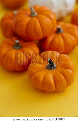 Halloweeen Theme With A Pumpkins On A Yellow Background