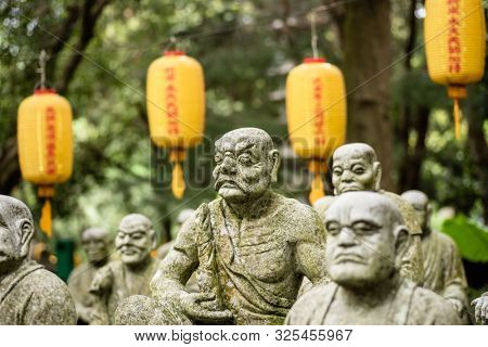 groups of buddhist arhat stone statue in the garden