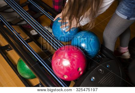 Close-up Hand Holding Bowling Ball Against Bowling Alley - Image. Cheerful Woman Isready To Play - I